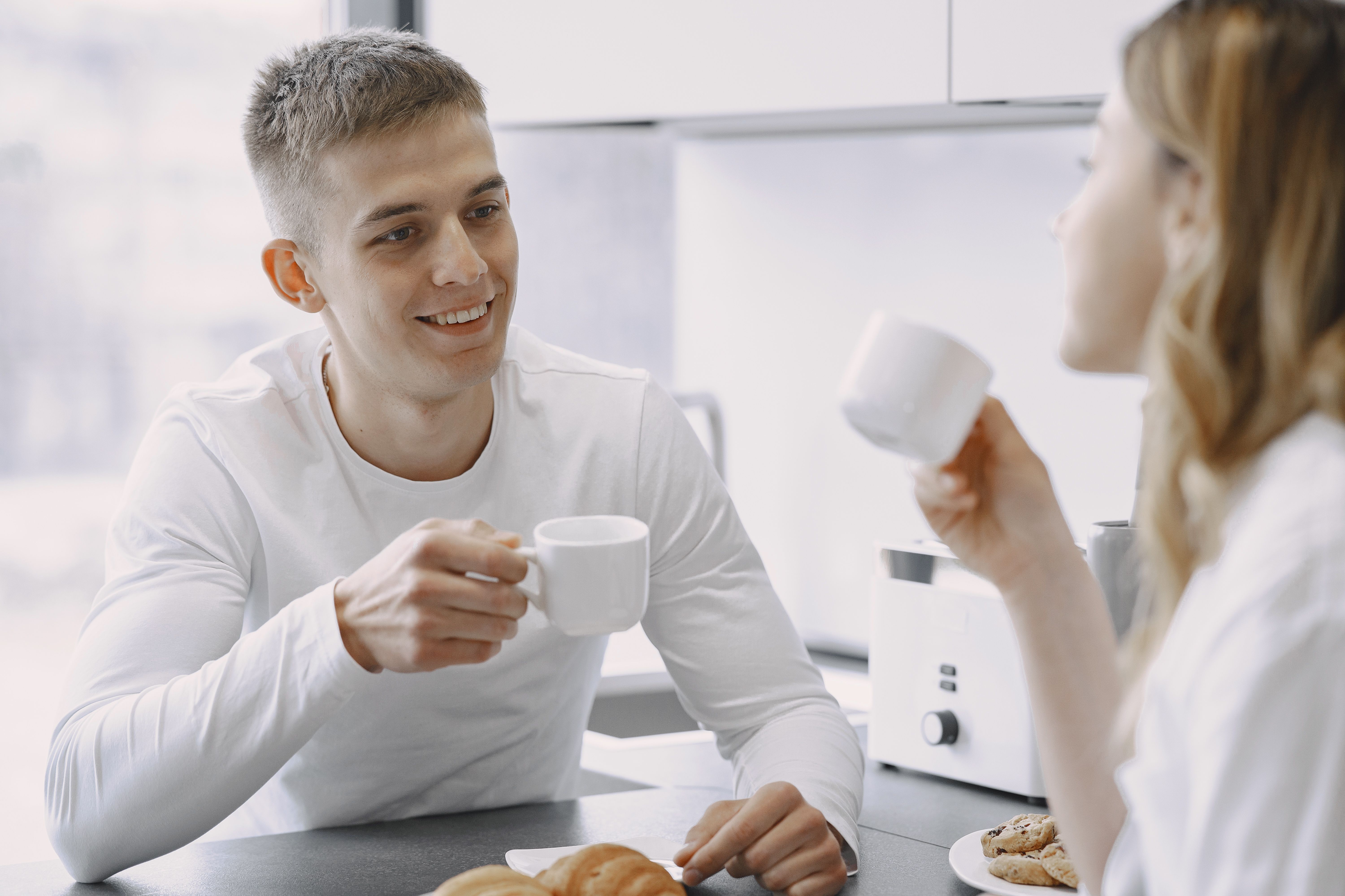 Healthy active person in a bright kitchen enjoying a morning coffee as part of a balanced daily wellness routine.